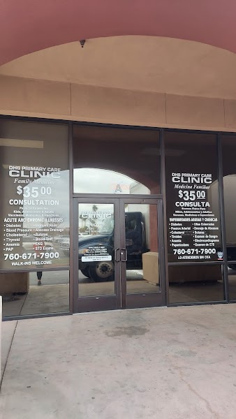 Clinic entrance with walk-in pricing in English and Spanish